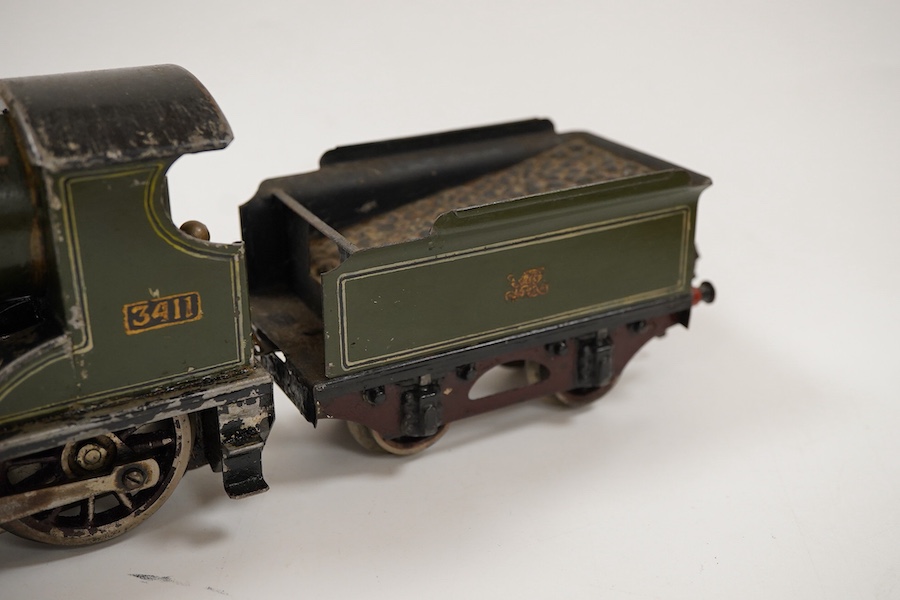 An 0 gauge live steam spirit fired tinplate GWR 4-4-0 tender locomotive, possibly Bing for Bassett-Lowke, 3411, with original fuel tank and burner, two controls in the cab and four wheel tender